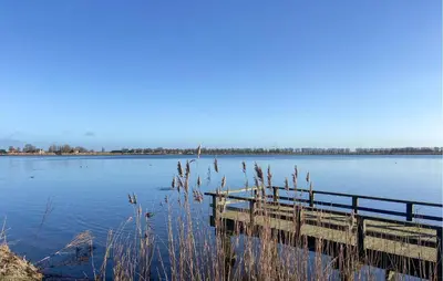 a wooden dock on a large body of water at Pet Friendly Home In Dirkshorn in Dirkshorn