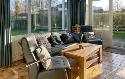 a living room with a couch and chairs and a table at Pet Friendly Home In Dirkshorn in Dirkshorn