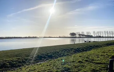 a view of a lake with the sun shining at Pet Friendly Home In Dirkshorn in Dirkshorn