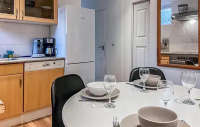 a kitchen with a table with wine glasses on it at Pet Friendly Home In Dirkshorn in Dirkshorn