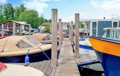 two boats are docked next to a dock at Havenlodge Amsterdam 1 in Amsterdam