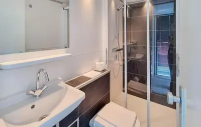 a bathroom with a toilet and a sink and a shower at Havenlodge Amsterdam 1 in Amsterdam