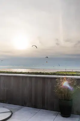 a view of a beach with birds flying in the sky at Enjoy Heaven in Schellinkhout