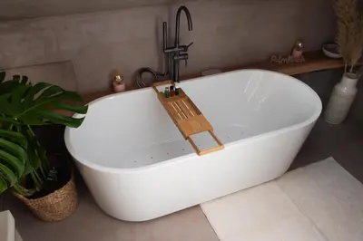 a white bath tub with a faucet in a bathroom at Enjoy Heaven in Schellinkhout