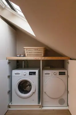 a laundry room with a washer and a washing machine at Enjoy Heaven in Schellinkhout