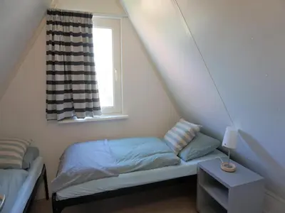 a small bedroom with a bed and a window at Holiday home in Burgerbrug for family in Burgerbrug