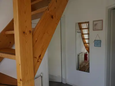 a staircase with wooden beams in a room at Holiday home in Burgerbrug for family in Burgerbrug