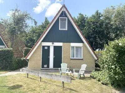 a small house with two chairs and a table at Holiday home in Burgerbrug for family in Burgerbrug