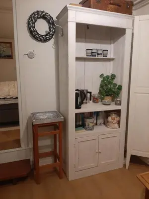 a large white cabinet in the corner of a room at Gezellig souterrain in bollestreek met prive ingang in Hillegom