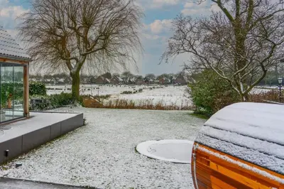 a snow covered car parked in front of a house at B&B Wellness 'De Bourgondische Lelie' in Bunschoten