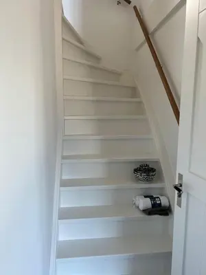 a stairway with a bottle of wine sitting on the floor at De Gouwe Leeuw in Woerdense Verlaat