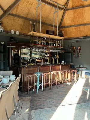 a bar in a restaurant with bar stools at De Gouwe Leeuw in Woerdense Verlaat