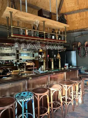 a bar with a row of stools in a restaurant at De Gouwe Leeuw in Woerdense Verlaat