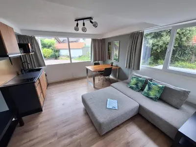 a living room with a couch and a table at Beautiful apartment close to sea Beach Life 51A in Noordwijk