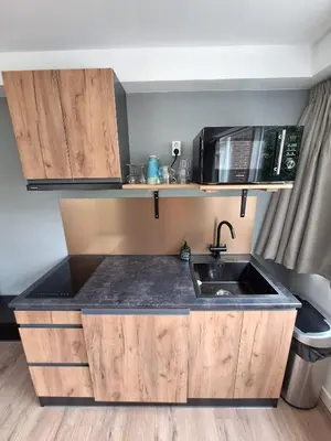a kitchen with a sink and a microwave at Beautiful apartment close to sea Beach Life 51A in Noordwijk