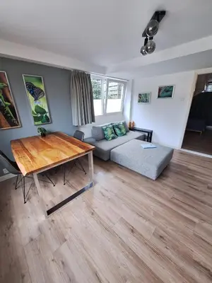 a living room with a couch and a table at Beautiful apartment close to sea Beach Life 51A in Noordwijk