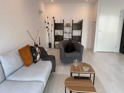 a living room with a couch and a table at Gateway to Amsterdam in Almere