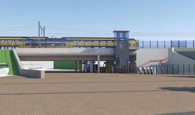 a train station with a train on a bridge at Gateway to Amsterdam in Almere