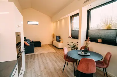 a small living room with a table and chairs at La Casa de Moerkapel in Moerkapelle