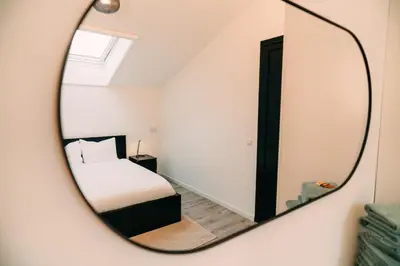 a bedroom with a bed and a mirror at La Casa de Moerkapel in Moerkapelle