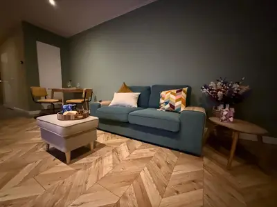 a living room with a blue couch and a table at cozy apartment in the centre of Gouda in Gouda