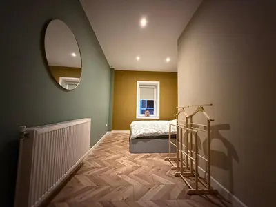 a small bedroom with a bed and a mirror at cozy apartment in the centre of Gouda in Gouda