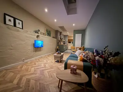 a living room with a blue couch and a tv at cozy apartment in the centre of Gouda in Gouda
