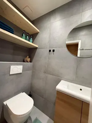 a bathroom with a toilet and a sink and a mirror at cozy apartment in the centre of Gouda in Gouda