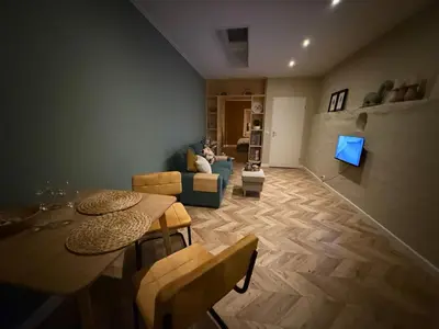 a living room with a person sitting on a couch at cozy apartment in the centre of Gouda in Gouda
