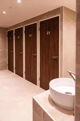 a bathroom with a sink and wooden cabinets at Cabins Hotel Amsterdam in Amsterdam