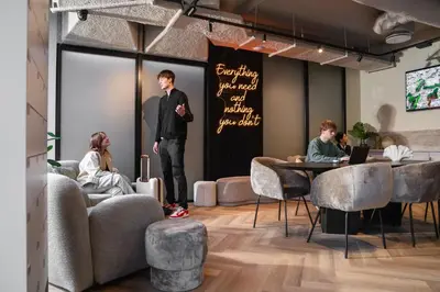 a man standing on a stage in a room at Cabins Hotel Amsterdam in Amsterdam