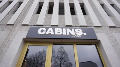 a building with a sign on top of it at Cabins Hotel Amsterdam in Amsterdam