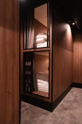 a room with a wooden cabinet with a closet with towels at Cabins Hotel Amsterdam in Amsterdam