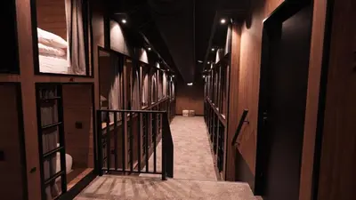 a hallway with wooden walls and a stairway with a door at Cabins Hotel Amsterdam in Amsterdam