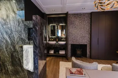 a living room with a fireplace and a mirror at Villa335 boutique b&b in Amsterdam