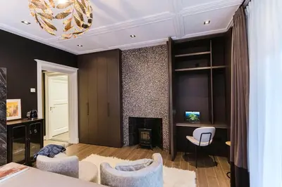 a living room with a fireplace and two chairs at Villa335 boutique b&b in Amsterdam