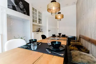 a dining room with a wooden table with dishes on it at Villa335 boutique b&b in Amsterdam