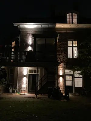 a house with a porch at night with lights at Villa335 boutique b&b in Amsterdam