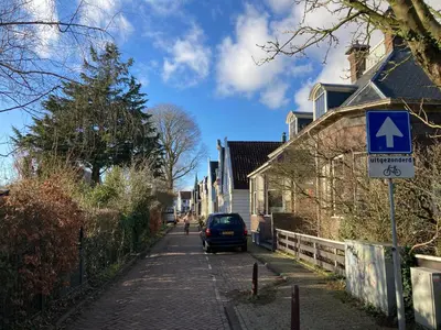 a car parked on a street with a blue sign at Villa335 boutique b&b in Amsterdam