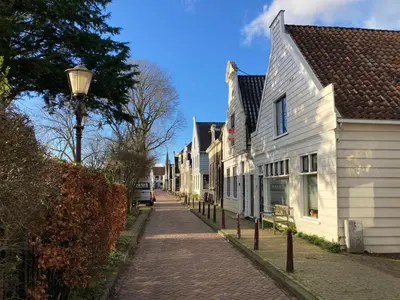 a cobblestone street with white houses and a street light at Villa335 boutique b&b in Amsterdam