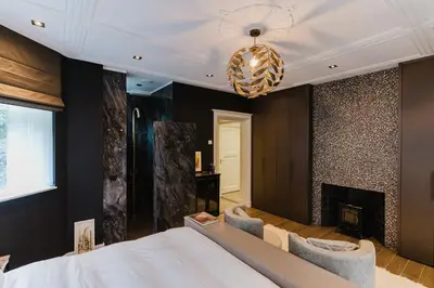 a bedroom with a fireplace and a bed at Villa335 boutique b&b in Amsterdam