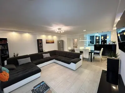 a living room with a couch and a table at Deluxe Estate in Hoofddorp