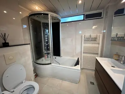 a bathroom with a tub and a toilet and a sink at Deluxe Estate in Hoofddorp