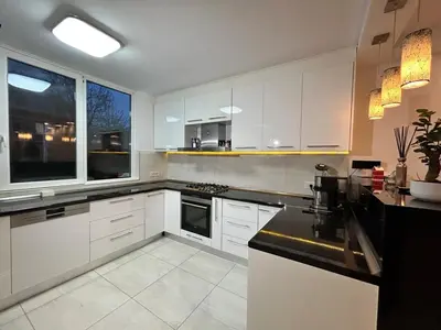 a kitchen with white cabinets and a black counter top at Deluxe Estate in Hoofddorp