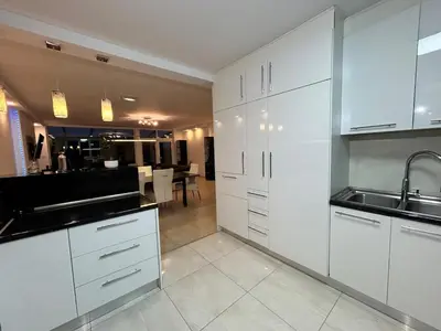 a kitchen with white cabinets and a sink at Deluxe Estate in Hoofddorp