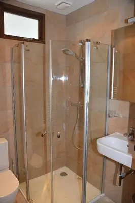 a bathroom with a shower and a toilet and a sink at Guesthouse 70m2 with private garden and free parking in Rijnsburg