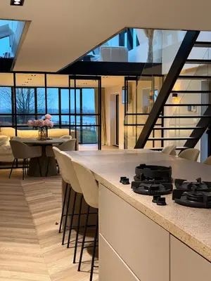 a kitchen with a counter with a stove top at Luxury Apartment near Amsterdam in Purmerland