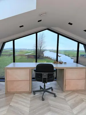 a office with a desk and a chair in front of a window at Luxury Apartment near Amsterdam in Purmerland