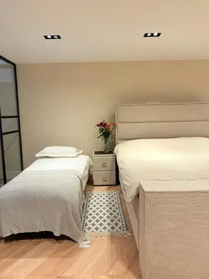 two beds sitting next to each other in a bedroom at Luxury Apartment near Amsterdam in Purmerland