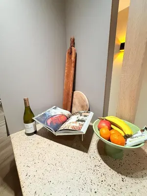 a table with a book and a bowl of fruit at Luxury Apartment near Amsterdam in Purmerland